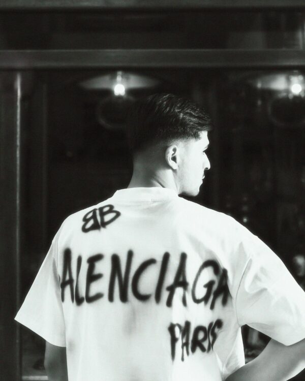 Fashionable black and white photo of a male model wearing a Balenciaga T-shirt.