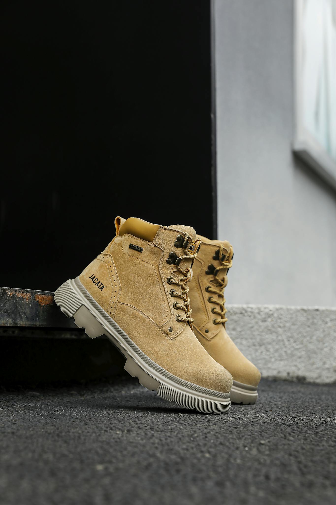 High-quality brown leather boots pictured outdoors on a textured surface. Ideal for fashion and lifestyle themes.