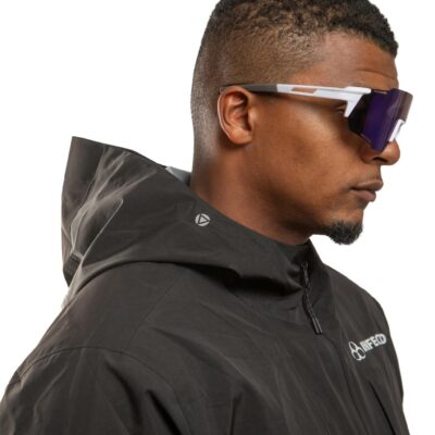 Profile of a fashionable man wearing sunglasses and a black winter jacket.