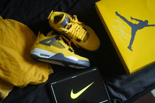 Yellow sneakers with matching box and logo create a bold fashion statement.